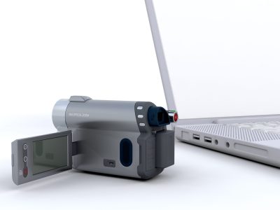 3D handy cam next to a laptop isolated on white